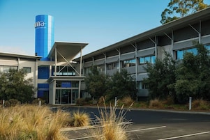 A modern building with a prominent blue tower labeled 'INTRA SMART AIRPORT.'
