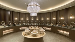 A luxurious buffet area with a central round table surrounded by food stations, each with a glass dome cover. - Monarch Plaza Hotel (Taoyuan City)