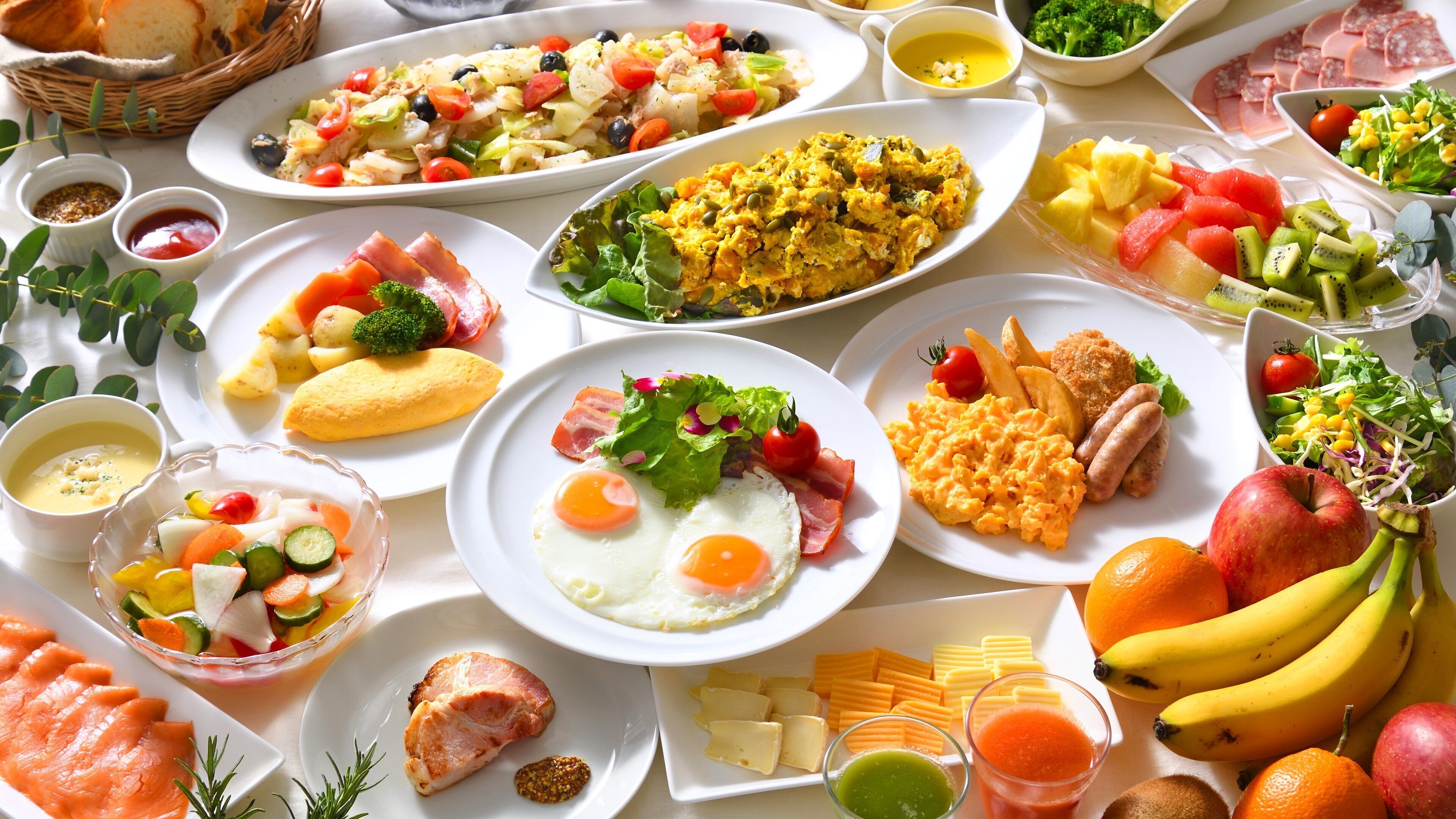 A variety of breakfast dishes including eggs, bacon, and fruit.