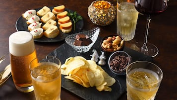 A table set with various snacks, drinks, and a decorative candle.