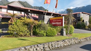 A hotel with a sign reading "Glacier Country Heartland Hotels." - Heartland Hotel Glacier Country (Fox Glacier)