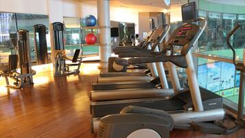 A gym with treadmills, exercise balls, and weight machines.