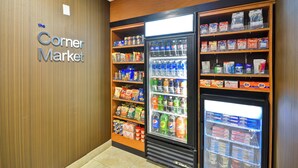 A corner market with shelves stocked with snacks, beverages, and household items. - Fairfield Inn & Suites by Marriott Tampa Fairgrounds/Casino (Tampa)