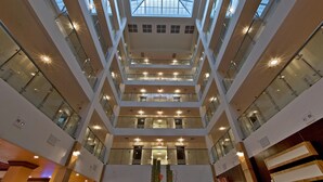 A multi-level atrium with glass railings and a central skylight.