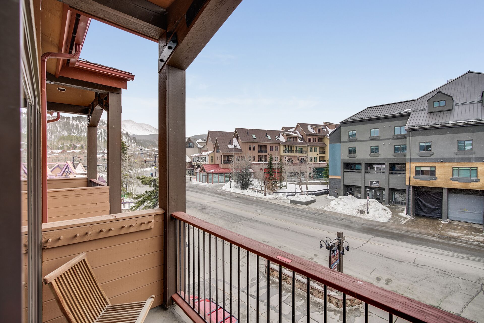 A balcony with a view of a street and buildings.
