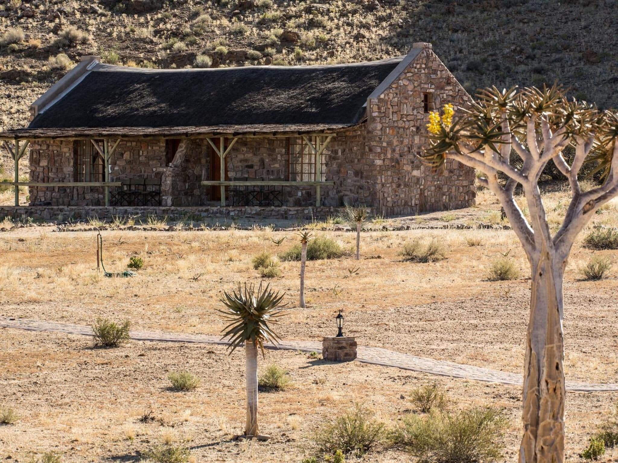 A stone building with a flat roof and a small porch.