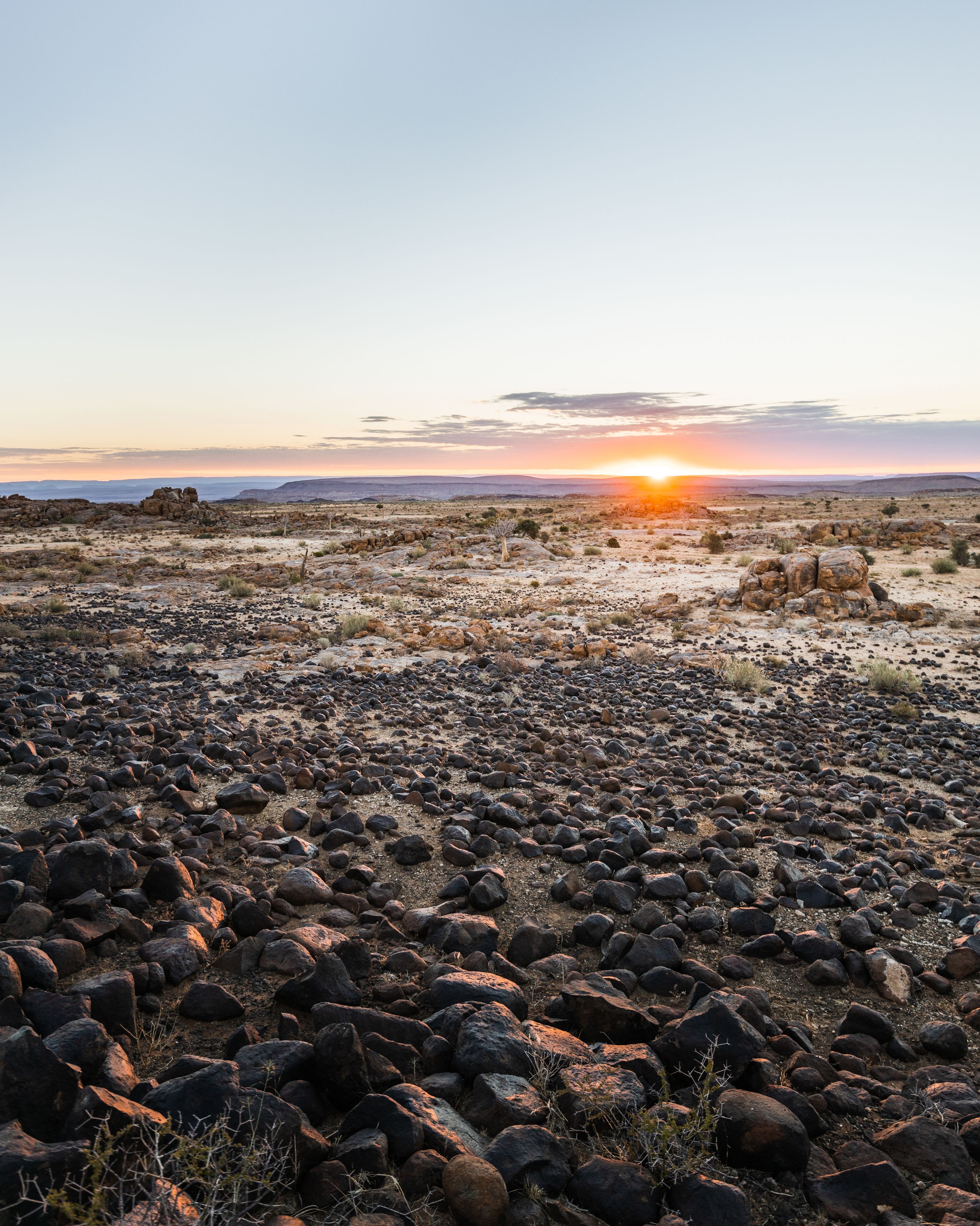A rocky landscape with a sunset in the background.