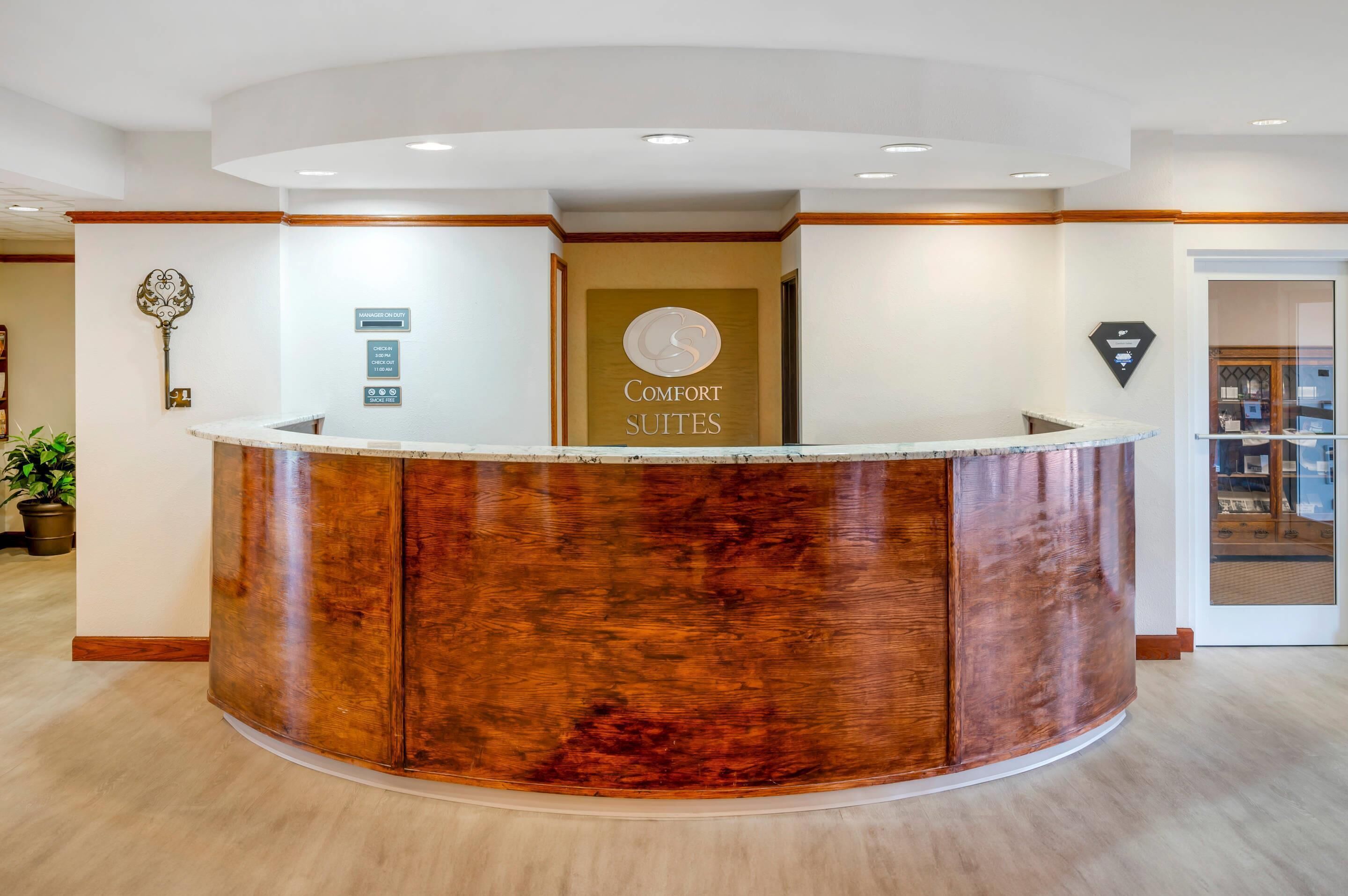 A reception desk with a sign for 'Comfort Suites'.