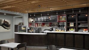 Eine moderne Bar mit Theke, Sitzgelegenheiten und einer Speisekarte.