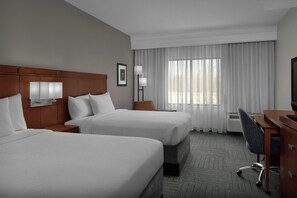 Premium bedding, pillow-top beds, desk, laptop workspace