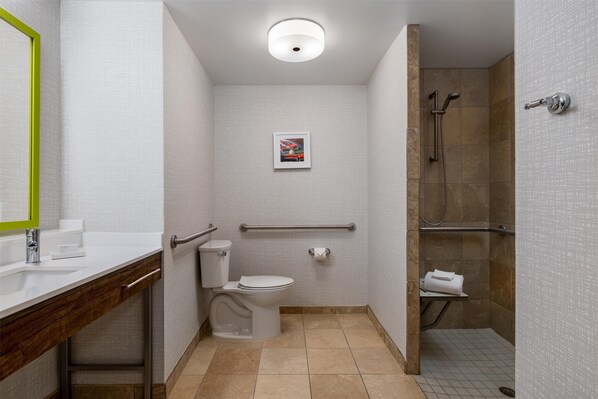 A bathroom with a toilet, sink, and shower.