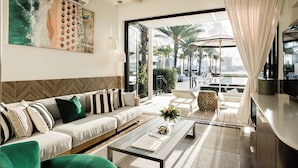 A modern living room with a sofa, coffee table, and artwork.