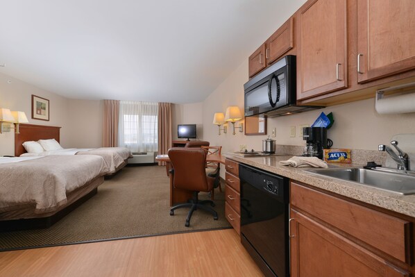 A hotel room with two beds, a desk, a television, a microwave, a coffee maker, and a sink. - Candlewood Suites Gillette by IHG (Gillette)