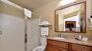 A bathroom with a shower, toilet, sink, and mirror. - Candlewood Suites Gillette by IHG (Gillette)