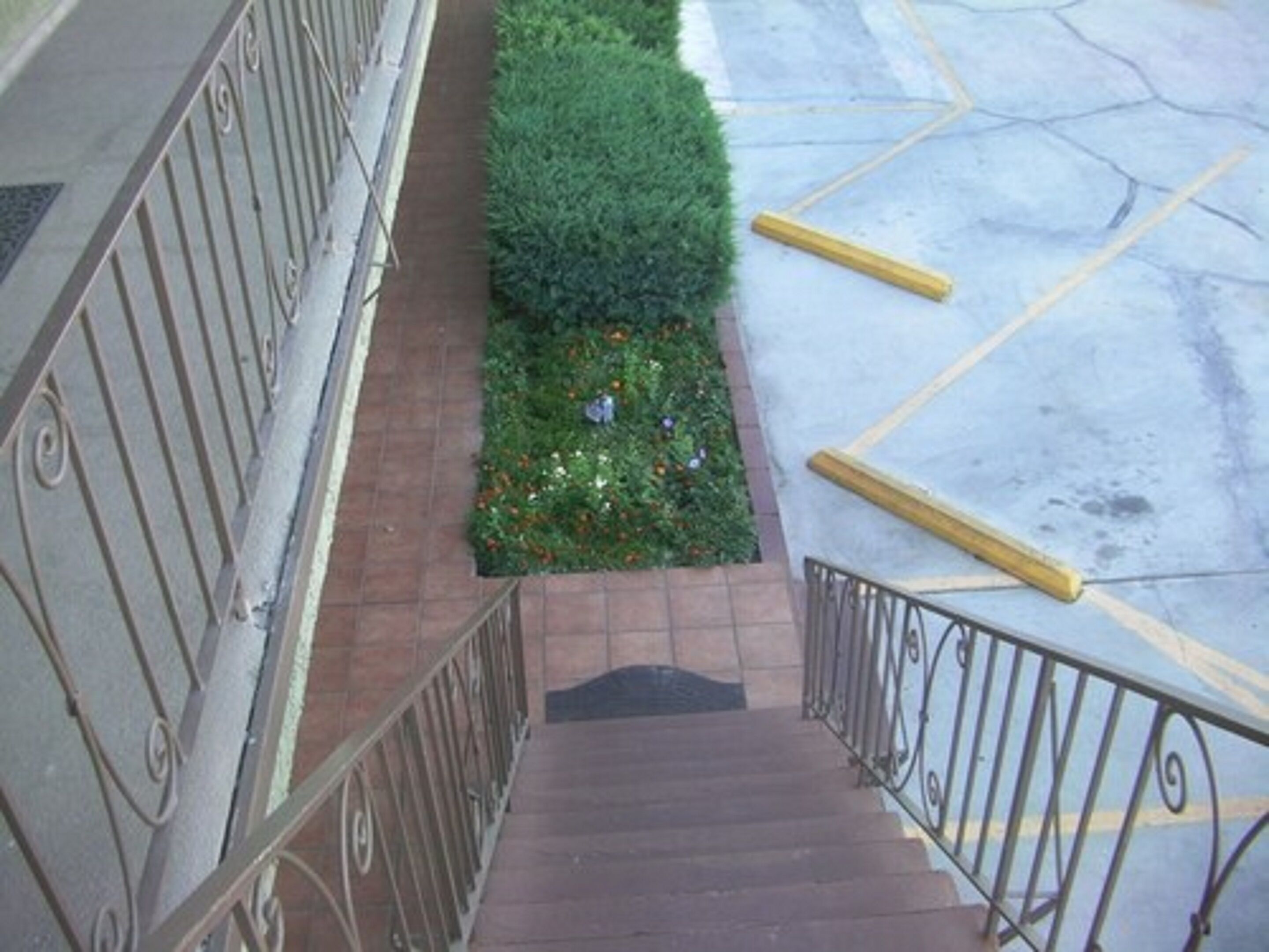 A staircase with metal railings leading to a landing.