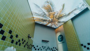 A spa area with a tiled wall, a water feature, and a sign for DomManuel Spa Wellness. - Gran Hotel Don Manuel (Cáceres)