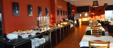 A buffet setup with various food items and a long counter.