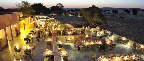 An outdoor dining area with tables and chairs arranged for guests.