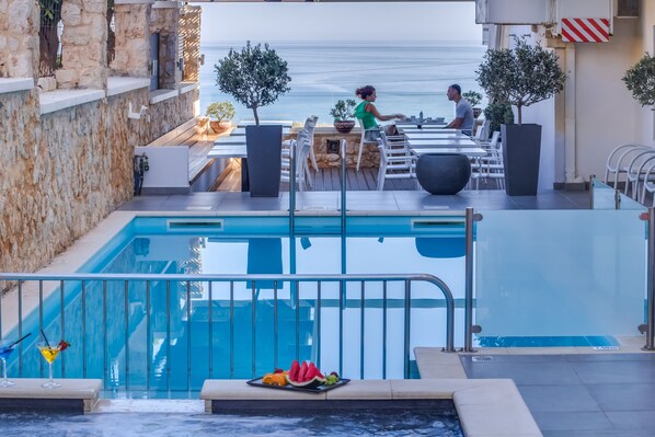 Seasonal outdoor pool, open 8:30 AM to 8:30 PM, pool umbrellas