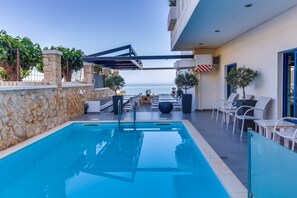 Seasonal outdoor pool, open 8:30 AM to 8:30 PM, pool umbrellas