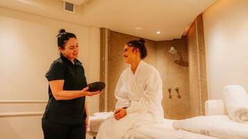 Experience rejuvenation in this serene space, featuring a massage table and amenities for ultimate relaxation.