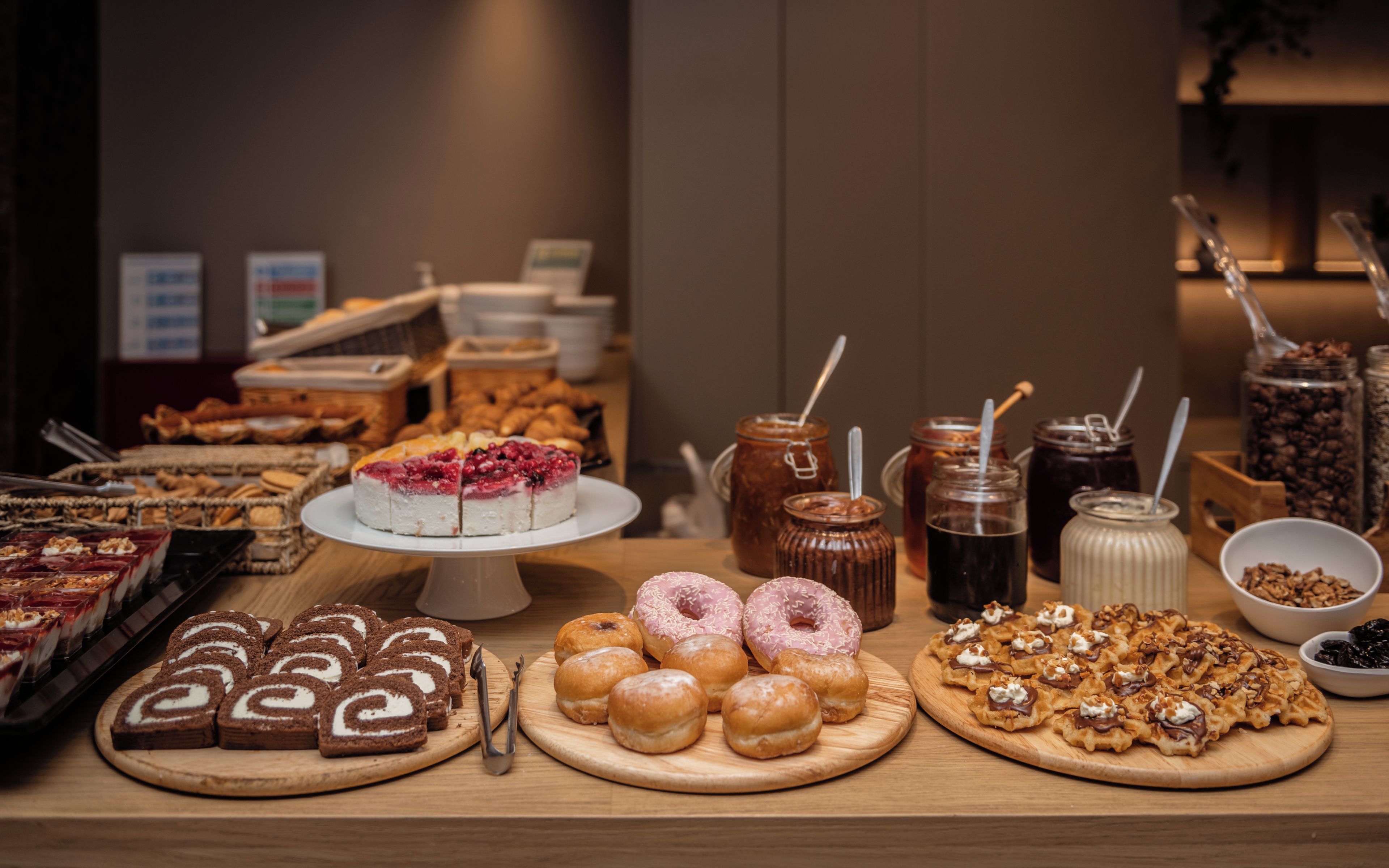 A buffet with various desserts and beverages.