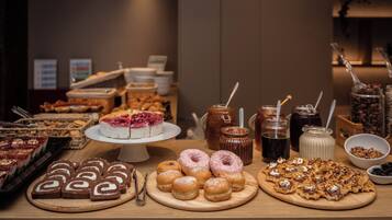 A buffet with various desserts and beverages.