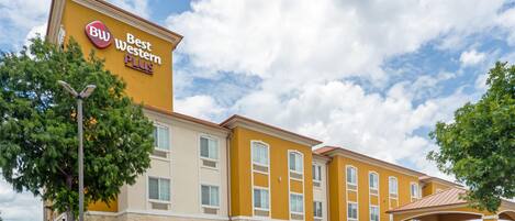 A Best Western Plus hotel with a yellow facade, multiple windows, and a covered entrance area.