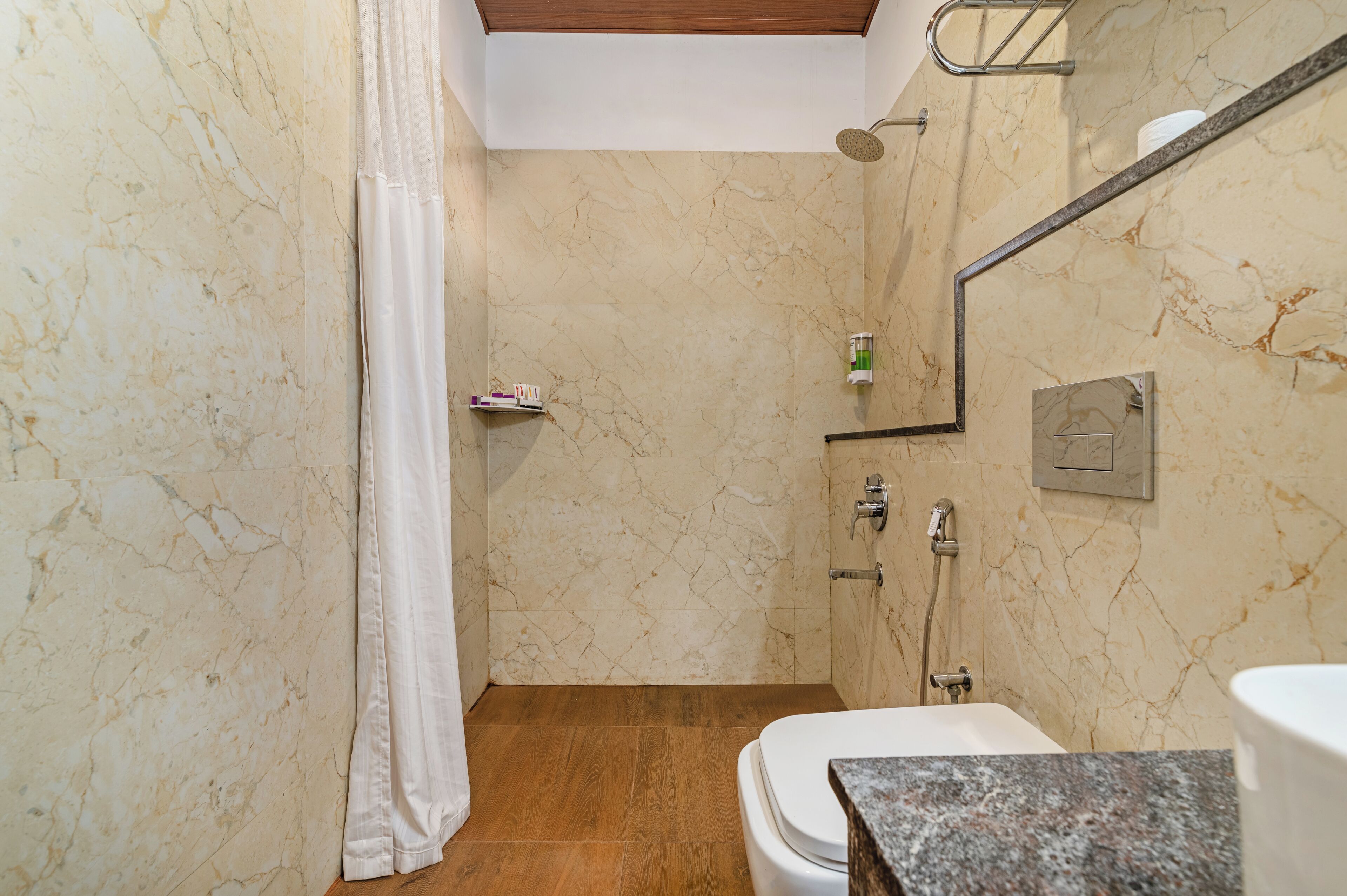 A bathroom with a shower, toilet, and sink.