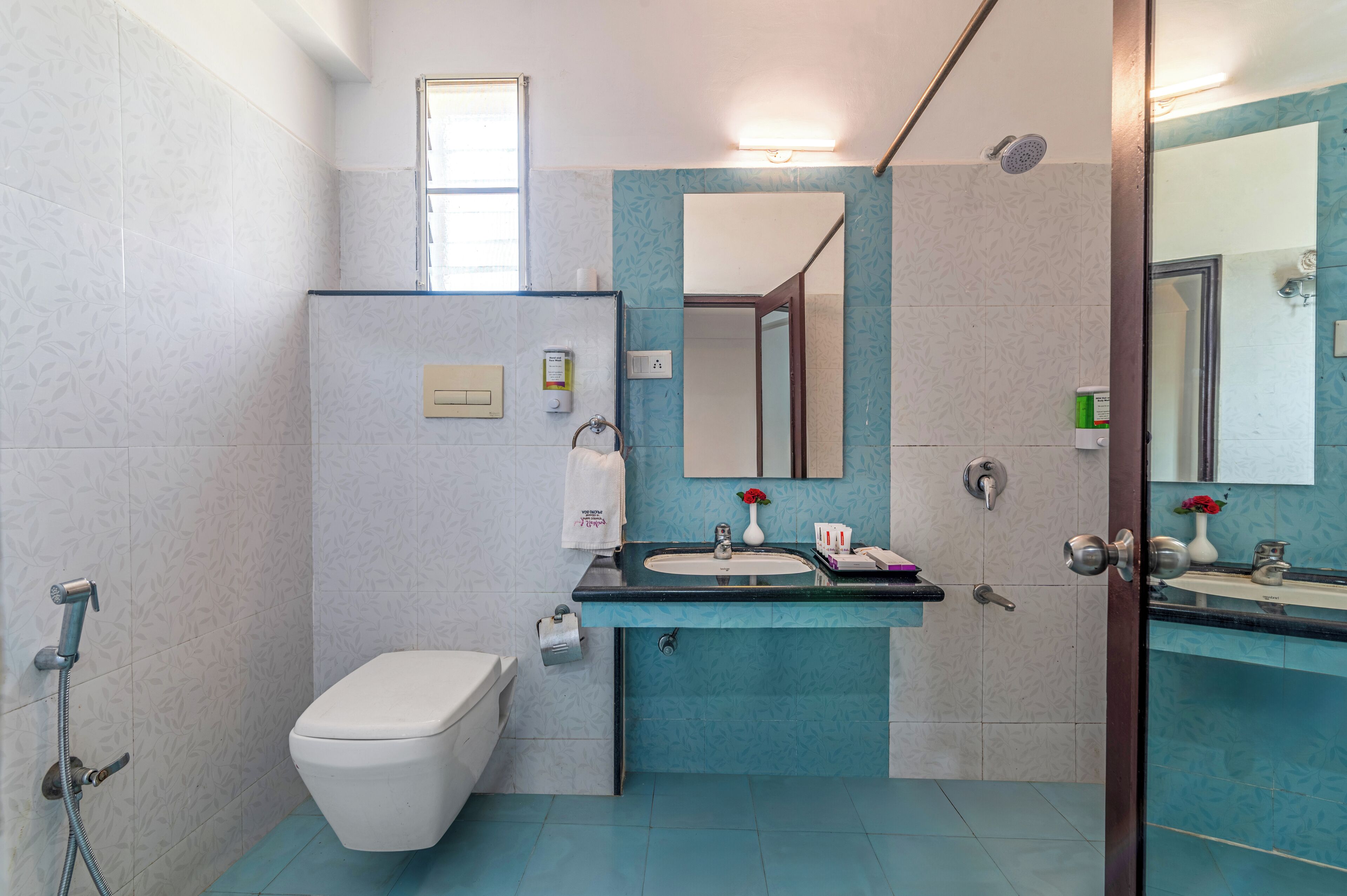 A bathroom with a toilet, sink, and shower.