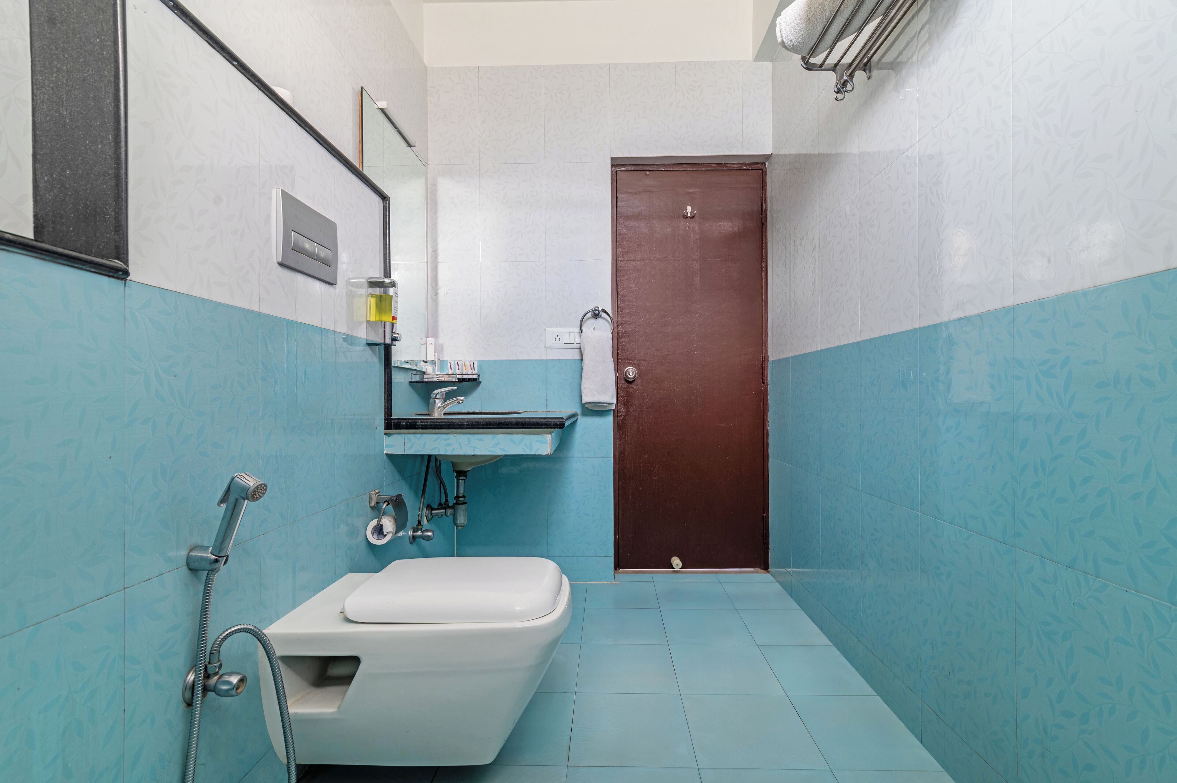 A bathroom with a toilet, sink, and shower.