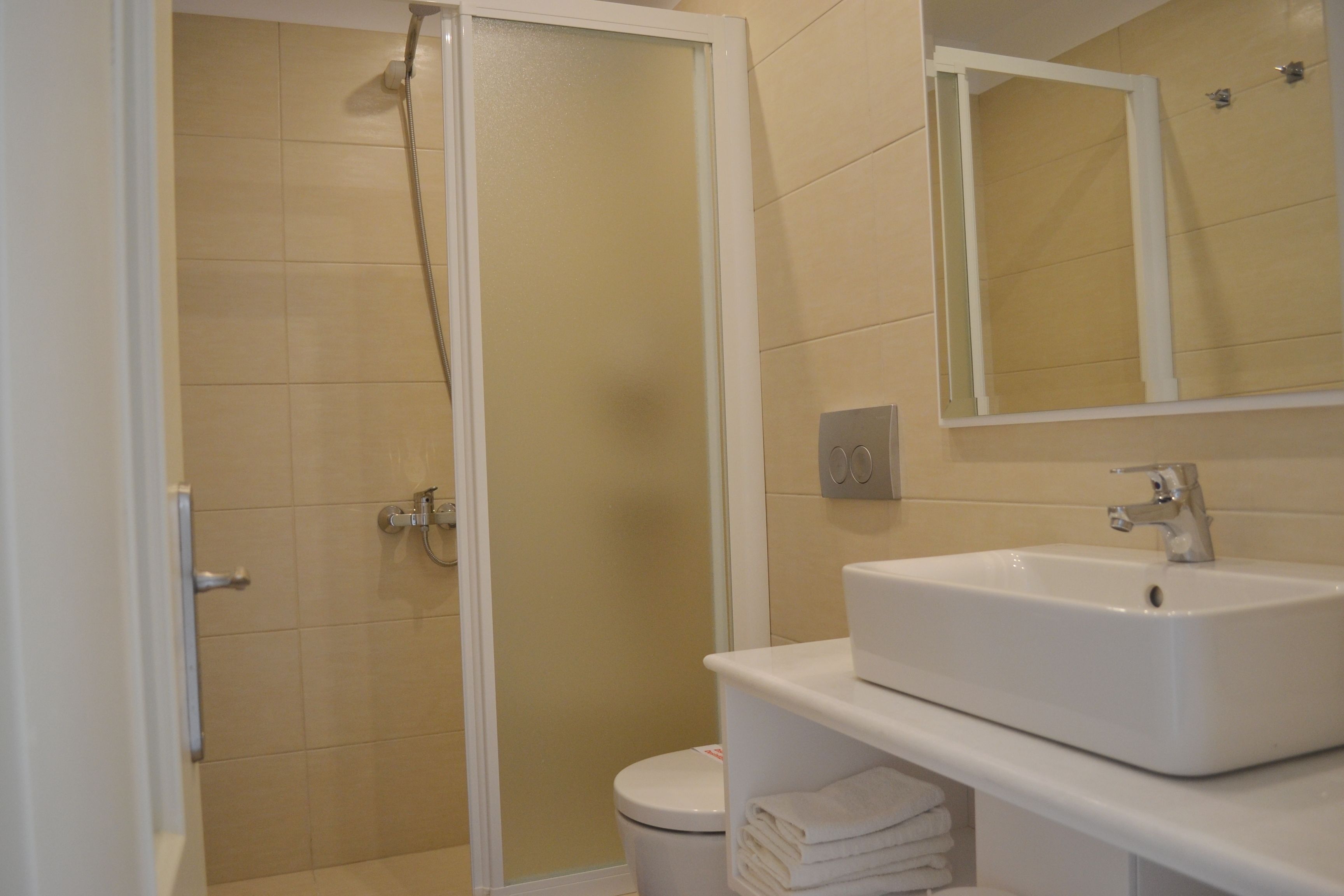 shower, hair dryer, slippers, towels