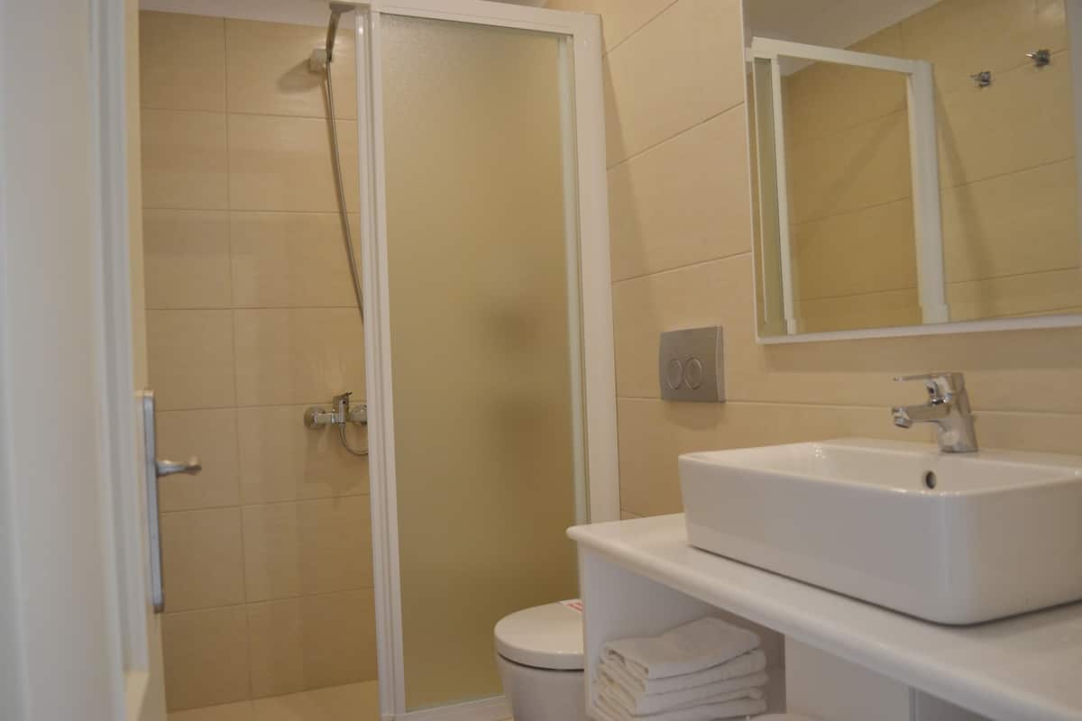 shower, hair dryer, slippers, towels