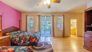 A bedroom with a bed, a nightstand, a dresser, a ceiling fan, and a view of the outside.