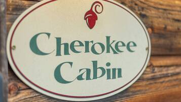 A circular sign with the text "Cherokee Cabin" and a red logo.