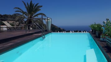 Outdoor pool, open 9 AM to 7 PM, pool umbrellas, sun loungers