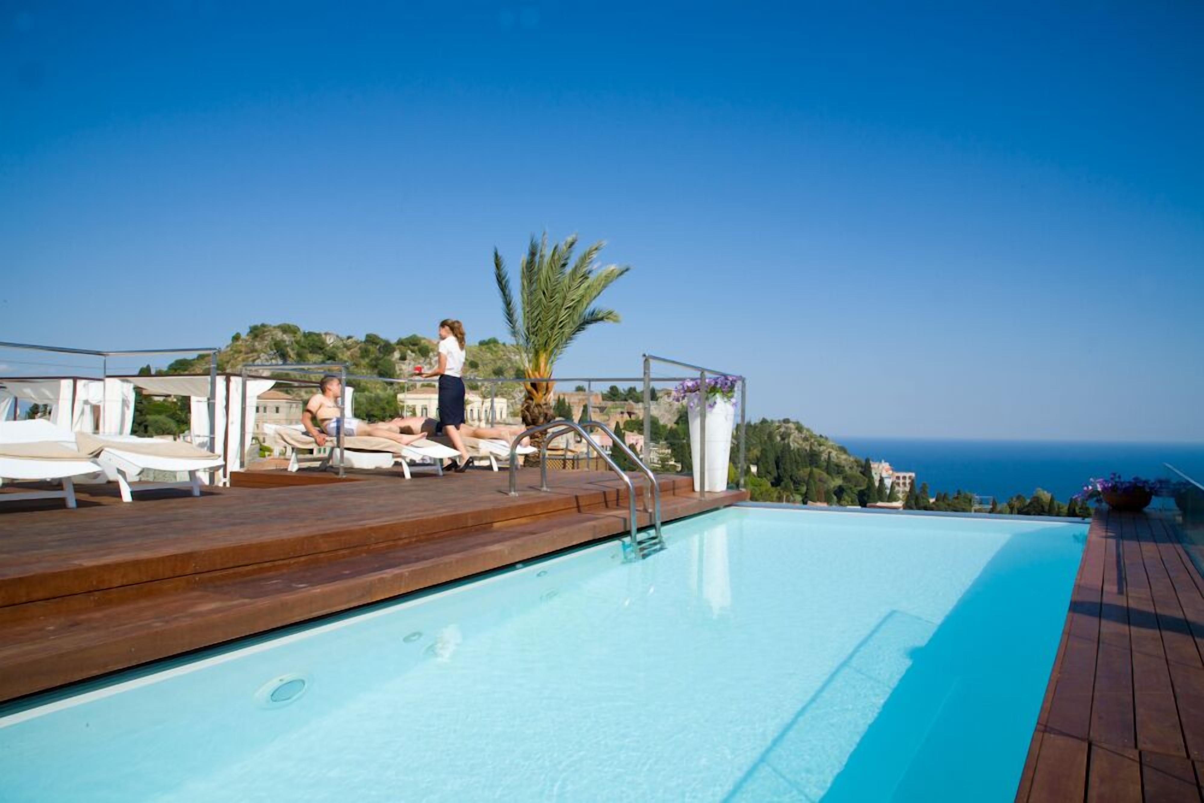 outdoor pool, open 9 am to 7 pm, pool umbrellas, pool loungers