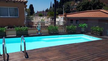 Outdoor pool, open 9 AM to 7 PM, pool umbrellas, sun loungers