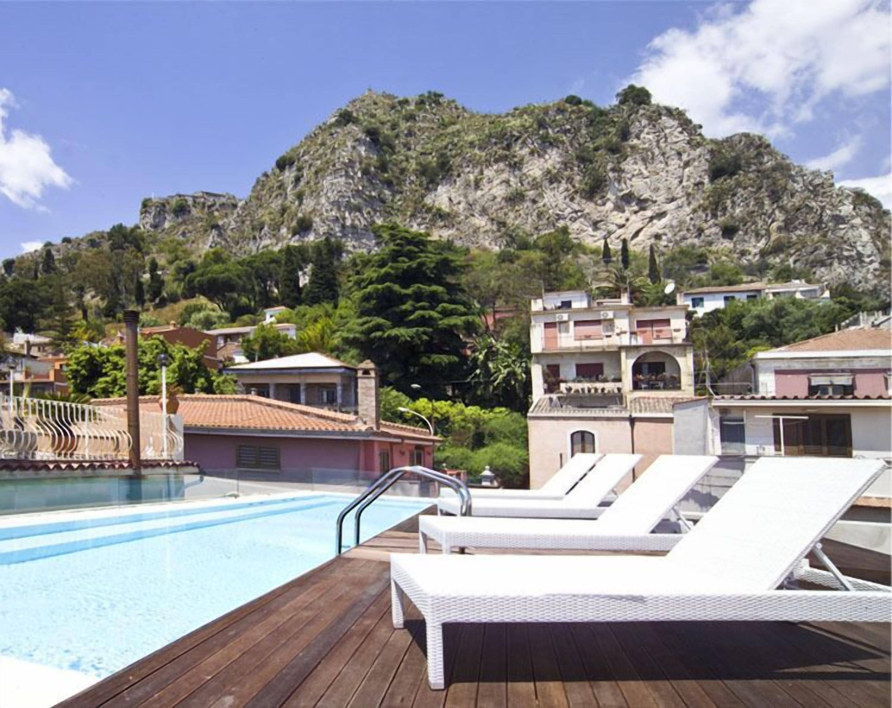 outdoor pool, open 9 am to 7 pm, pool umbrellas, pool loungers