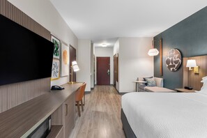 A hotel room with a bed, desk, chair, and a TV. - Holiday Inn Oklahoma City Airport by IHG (Oklahoma City)