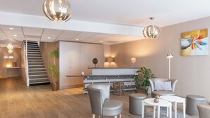 Un ambiente moderno con una scala, un’area salotto e una cucina.