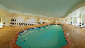 A large indoor swimming pool with a tiled deck, lounge chairs, and a poolside area. - Comfort Suites near Hot Springs Park (Hot Springs)