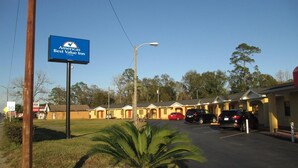 A motel with a sign for 'America's Best Value by Vantage Inn'.
