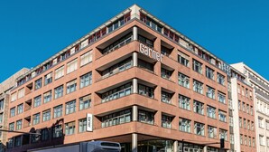 A multi-story building with a prominent 'Garnier' sign, featuring a modern architectural style with a red facade and multiple balconies. - Garner Hotel Berlin - Gendarmenmarkt by IHG (Berlin)