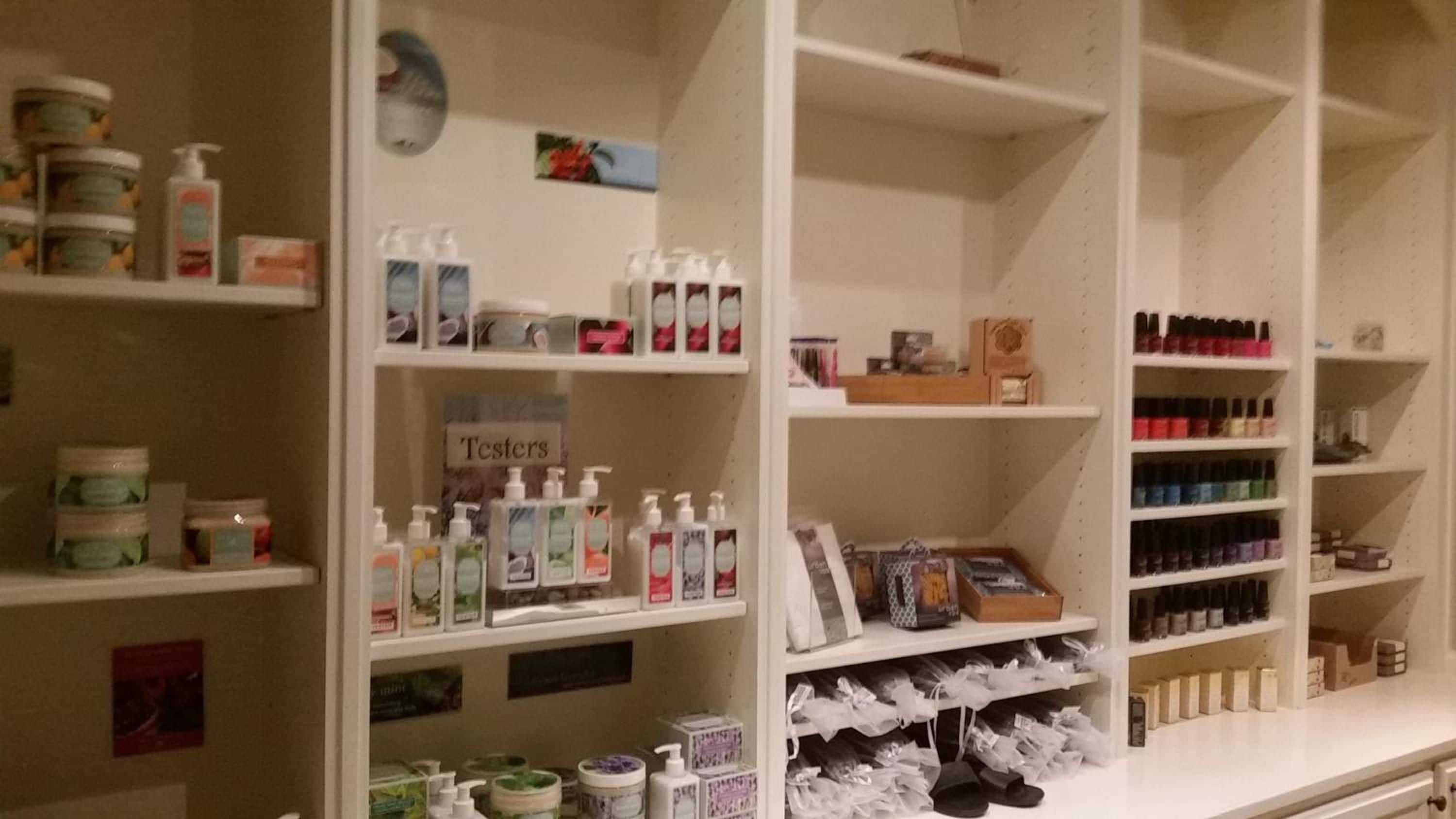 A store with shelves stocked with various personal care products, including lotions, shampoos, and nail polishes.