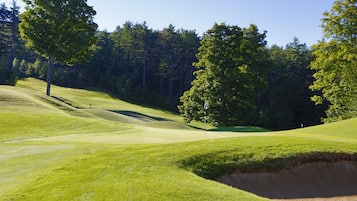 Enjoy a round of golf amidst lush green hills and tall trees.