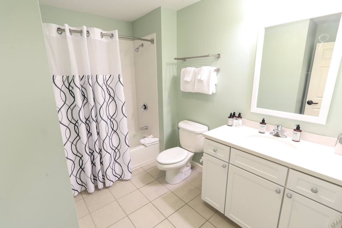 two bedroom executive suite | bathroom | combined shower/bathtub, deep-soaking bathtub, free toiletries
