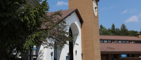 A church with a prominent tower and arched entrance.