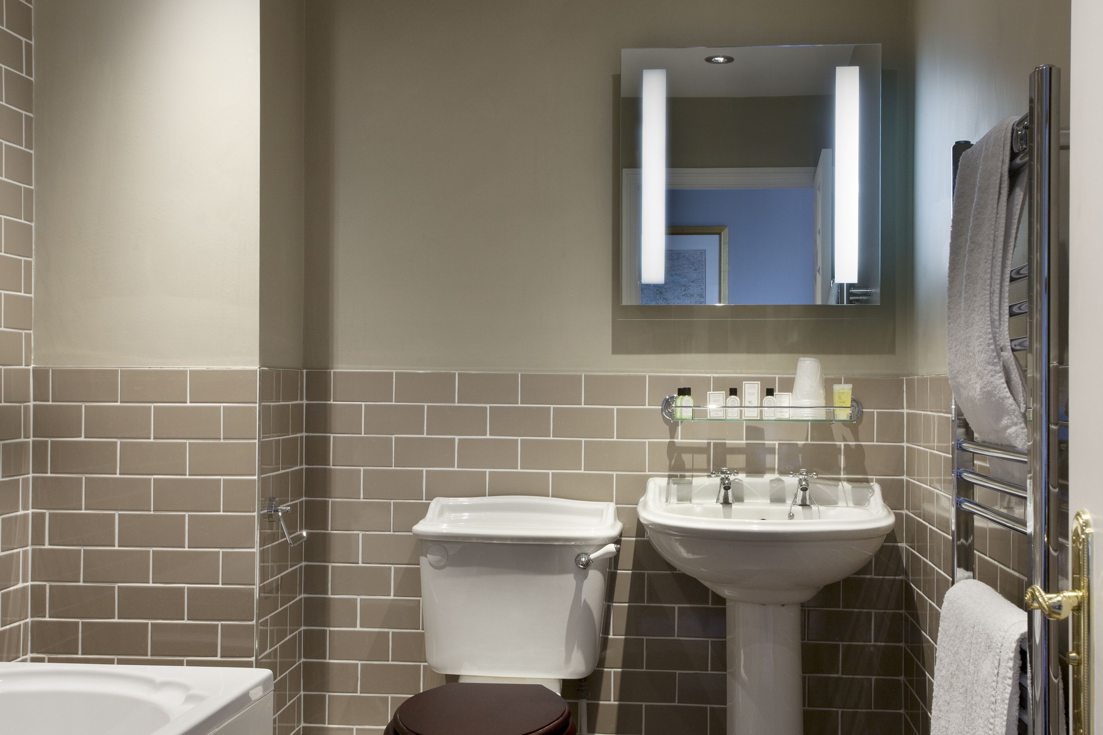 A bathroom with a toilet, sink, and bathtub.