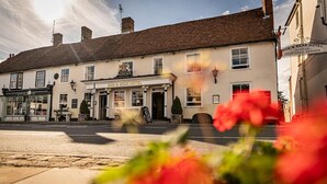 A traditional building with a sign reading "Dog & Bear Hotel" and a courtyard garden sign. - Dog & Bear Hotel (Maidstone)